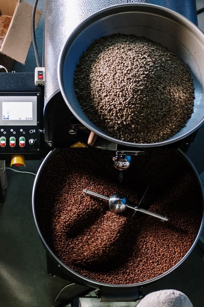 Freshly roasted coffee beans cooling in roaster